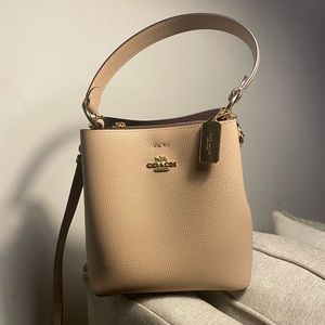 cream colored coach bucket bag